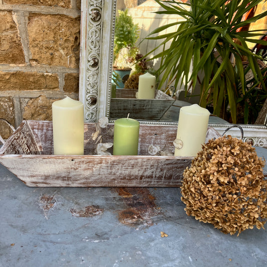A large wooden tray featuring handles at both ends, crafted with a rustic finish, ideal for decorative display