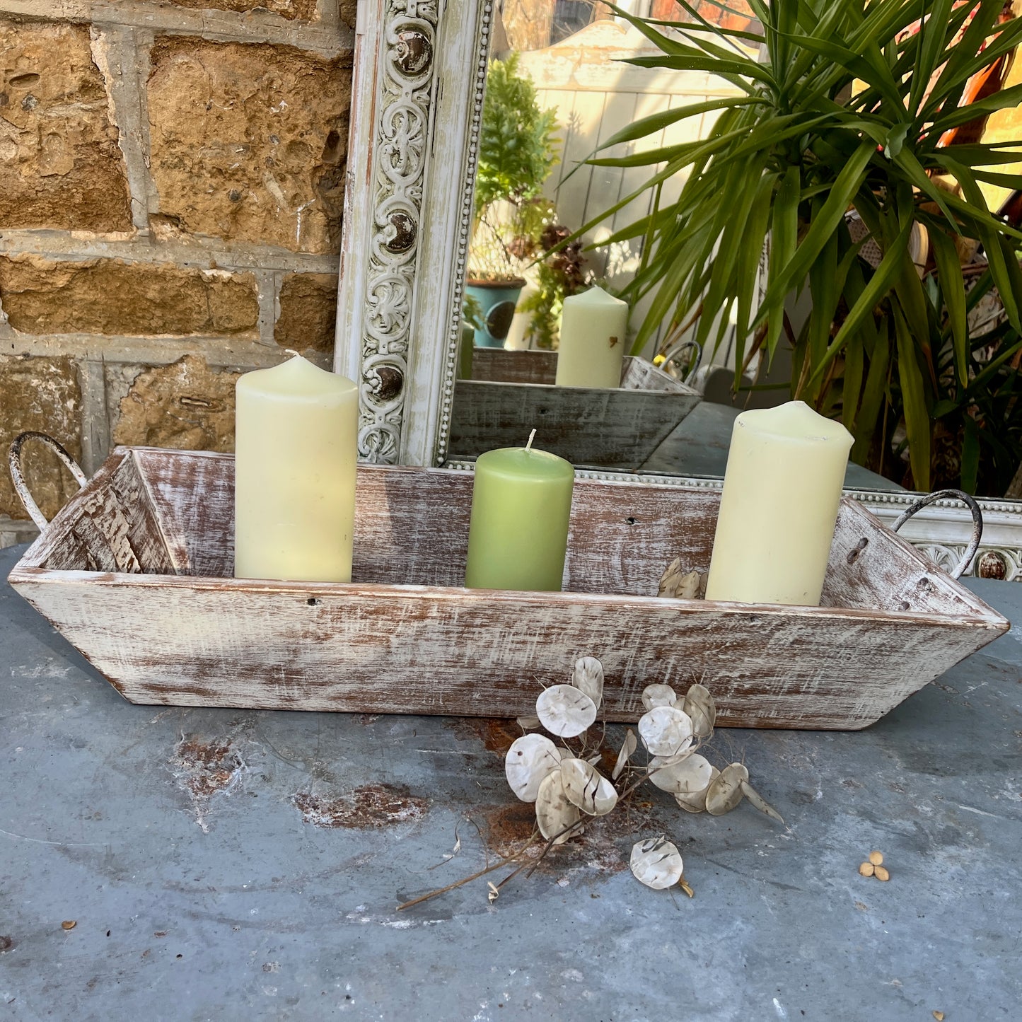 A large wooden tray featuring handles at both ends, crafted with a rustic finish, ideal for decorative display