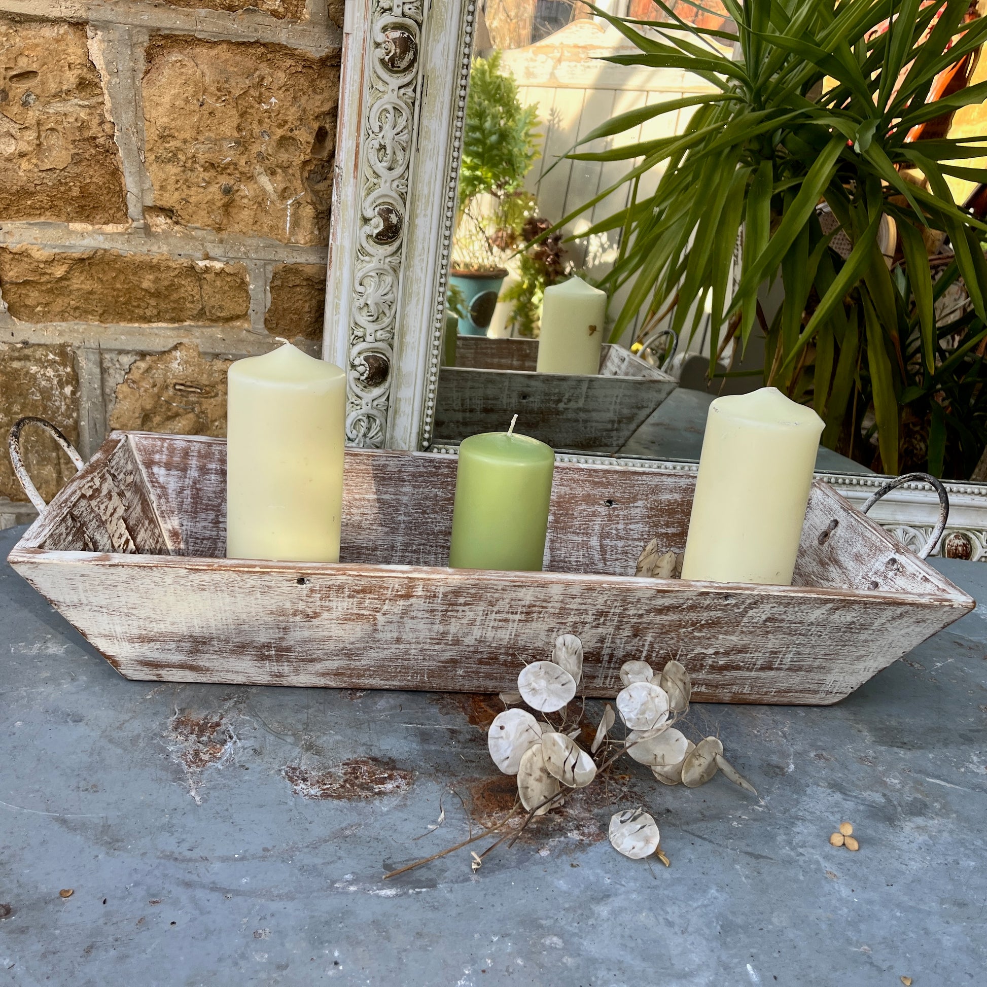 A large wooden tray featuring handles at both ends, crafted with a rustic finish, ideal for decorative display