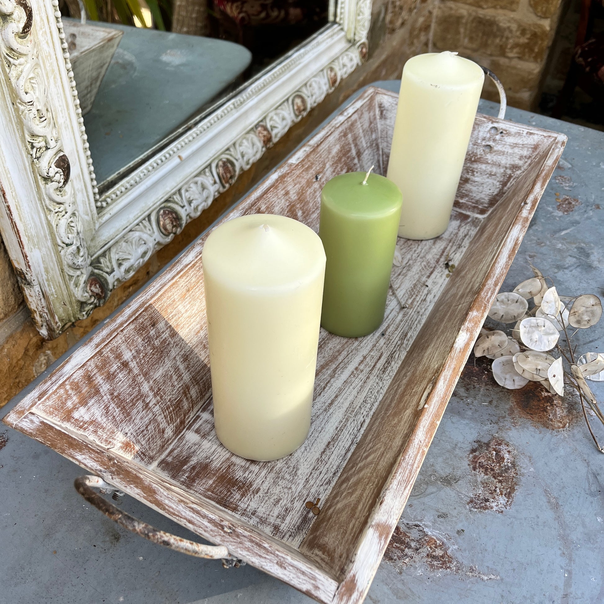 A large wooden tray featuring handles at both ends, crafted with a rustic finish, ideal for decorative display