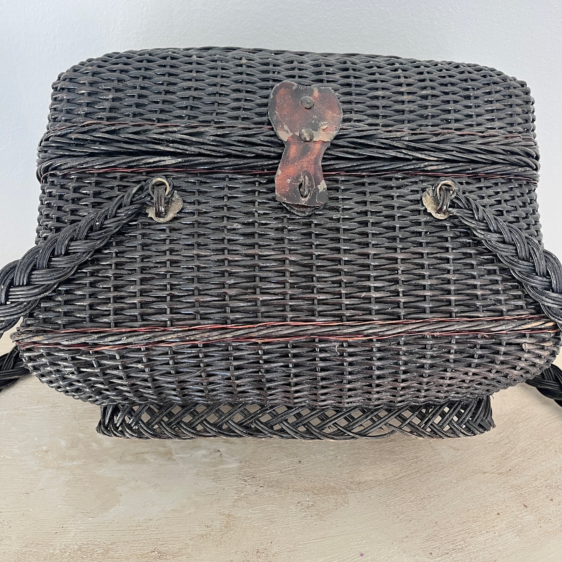 A Parisian handbag crafted from woven materials, showcasing intricate patterns and elegant design, inspired by French style