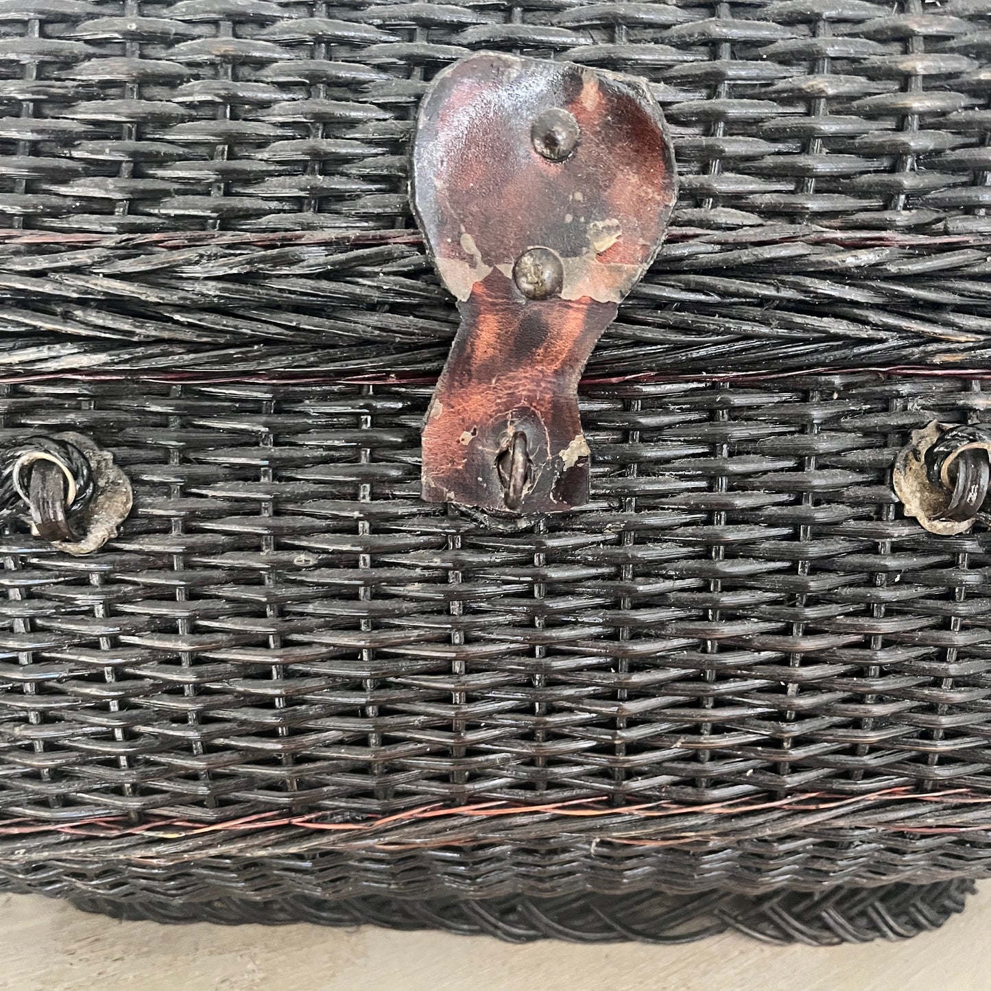 A Parisian handbag crafted from woven materials, showcasing intricate patterns and elegant design, inspired by French style
