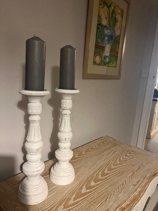 A pair of white rustic candle holders