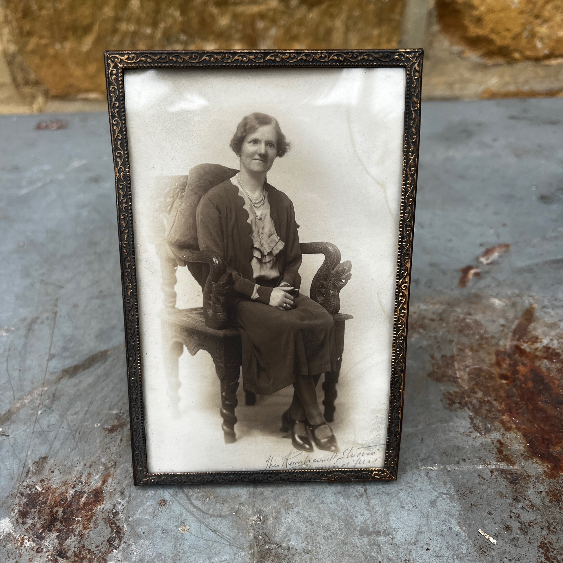 A vintage 1940s brass photo frame with a warm aged patina and classic Art Deco-inspired styling.