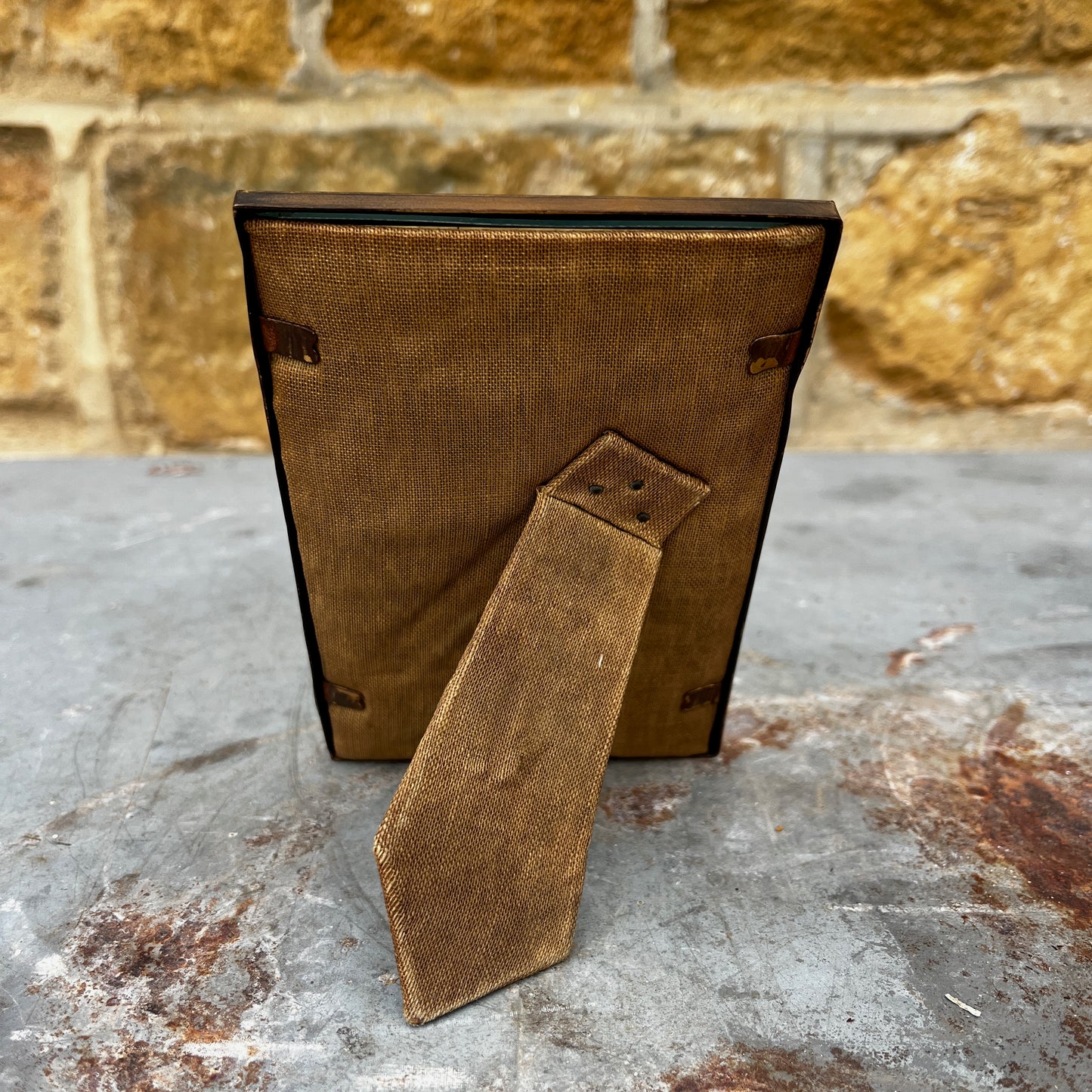 A vintage 1940s brass photo frame with a warm aged patina and classic Art Deco-inspired styling.