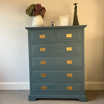 Blue chest of drawers with gold square handles