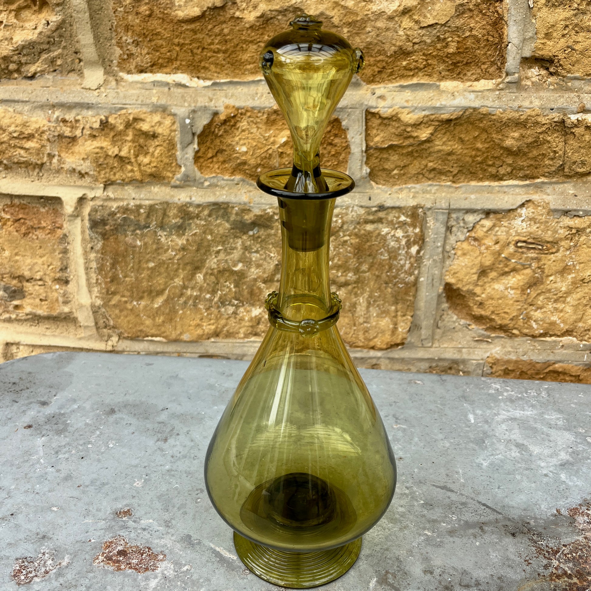 Green glass decantor with a textured stopper