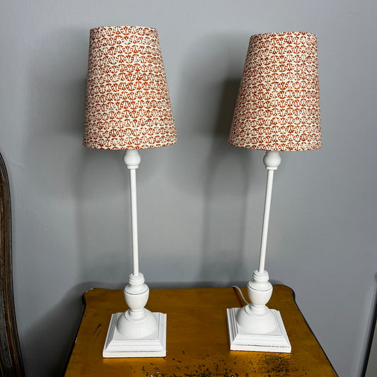 White bedside lamps with contemporary Jane Churchill fabric lampshade in rust.