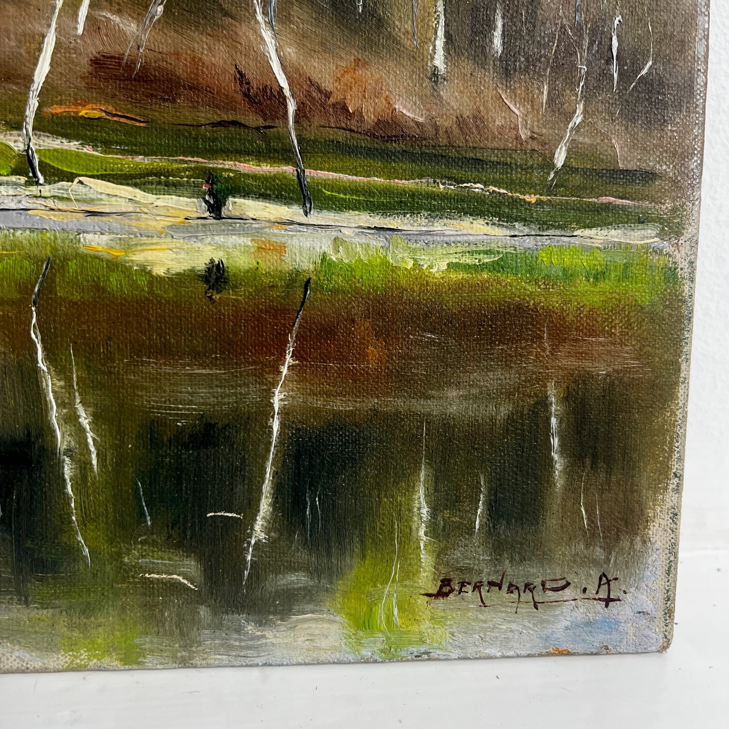 Painting of a forest landscape with trees reflected in water 