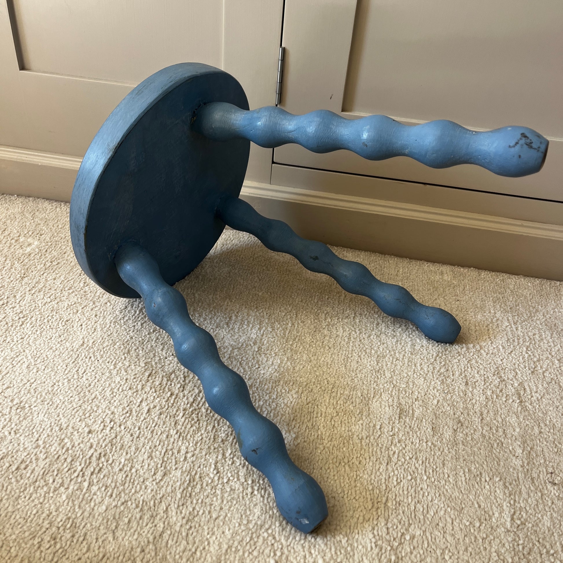 Wooden stool with three turned bobbin-style legs - painted blue and distressed