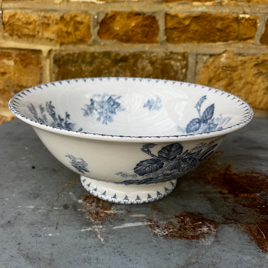 An antique French blue and white transferware bowl featuring an intricate floral and scenic pattern in classic cobalt blue on a white ceramic background