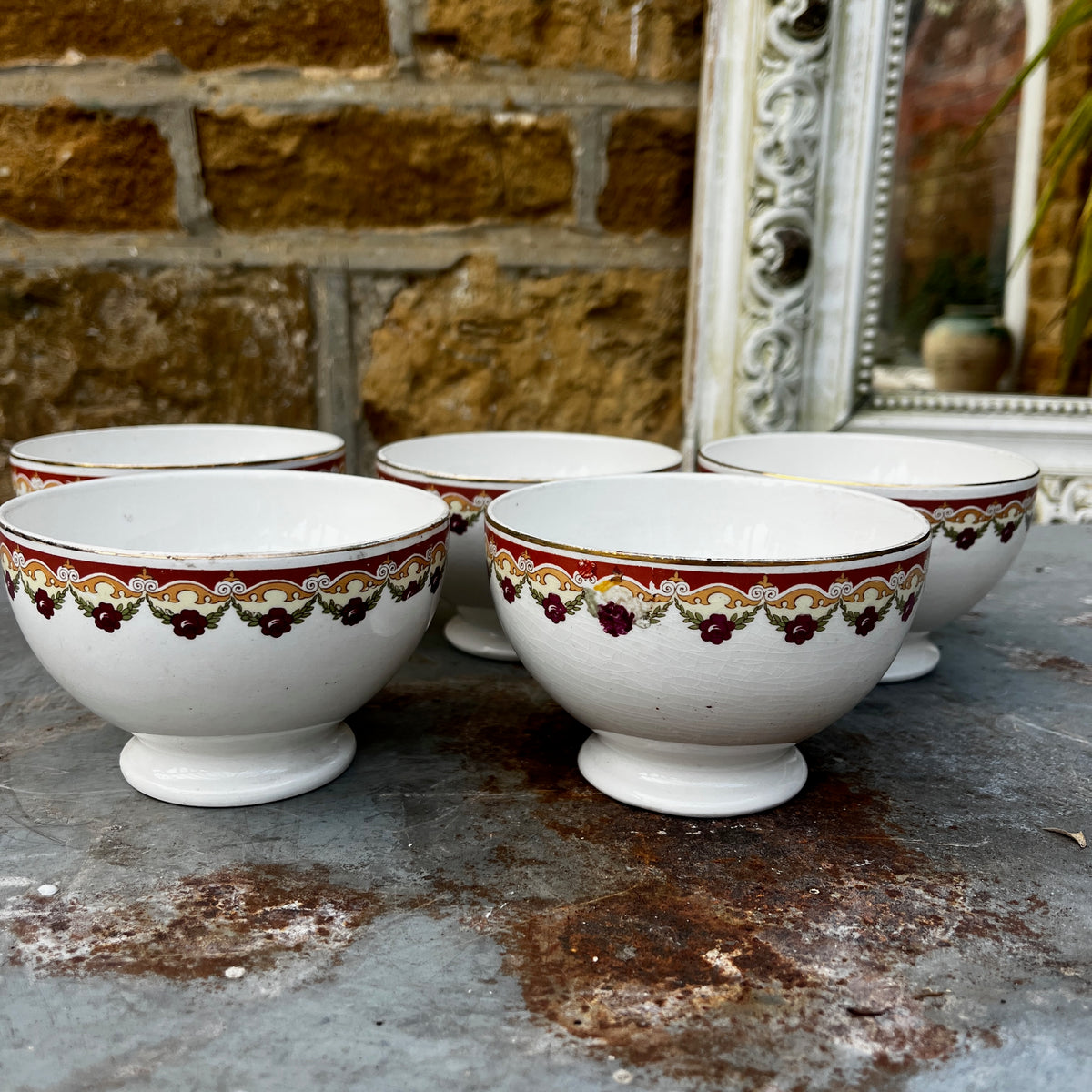 Vintage café au lait bowls with a maroon geometric pattern around the rim.