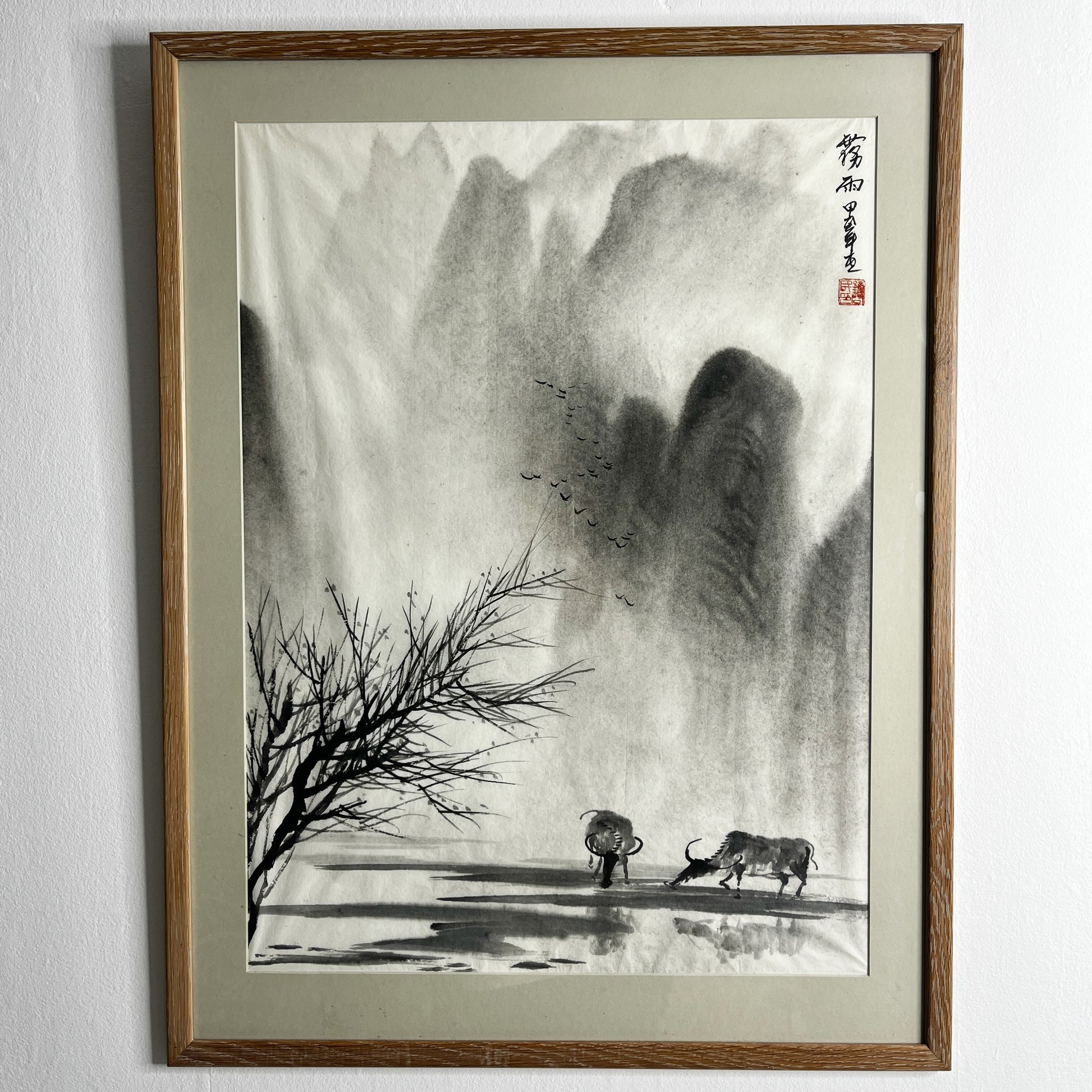 Original Chinese ink landscape painting on paper, attributed to Zhong Qi Min (Qi Min Zhong), depicting misty mountains and a tranquil riverside scene with two water buffalo. Trees appear in the foreground, with birds flying overhead, rendered in traditional expressive brushwork.