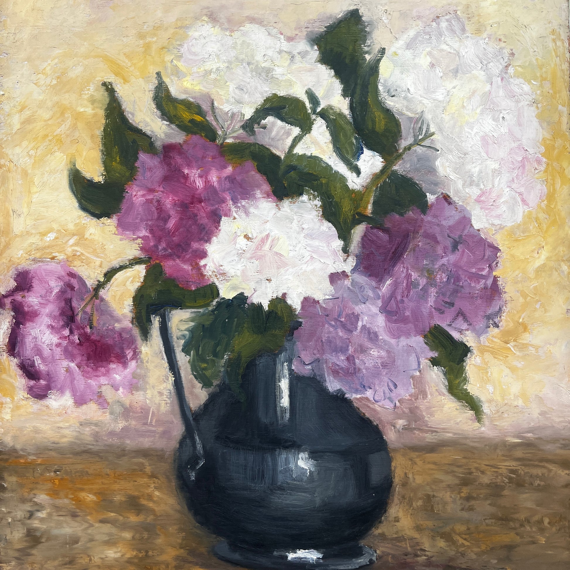 A portrait shape oil painting on board depicting a still life of purple and white flowers in a dark vase, displayed on a small wooden easel.