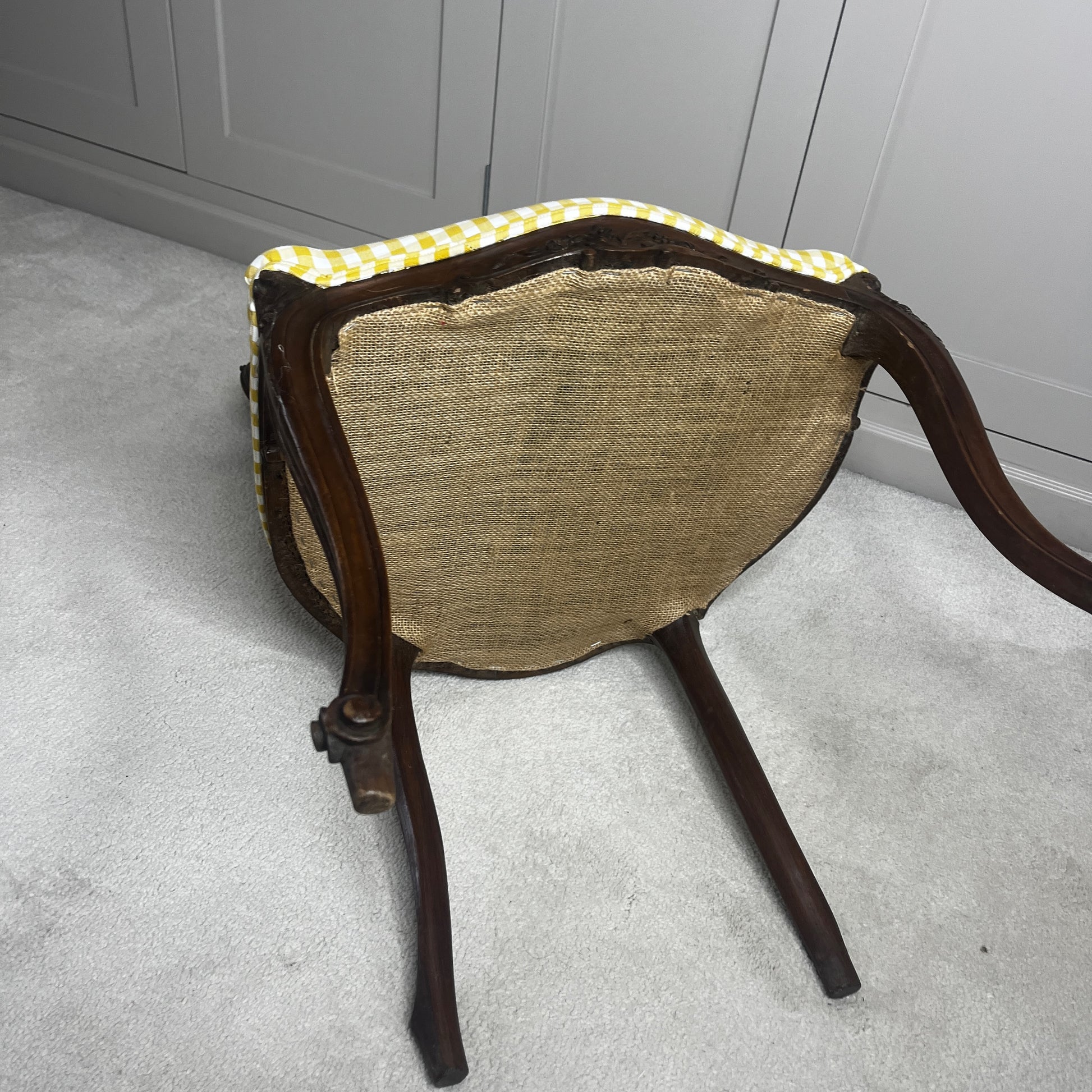 Pair of French salon chairs, newly upholstered in mustard gingham fabric, featuring elegant wooden frames and classic curved backs.