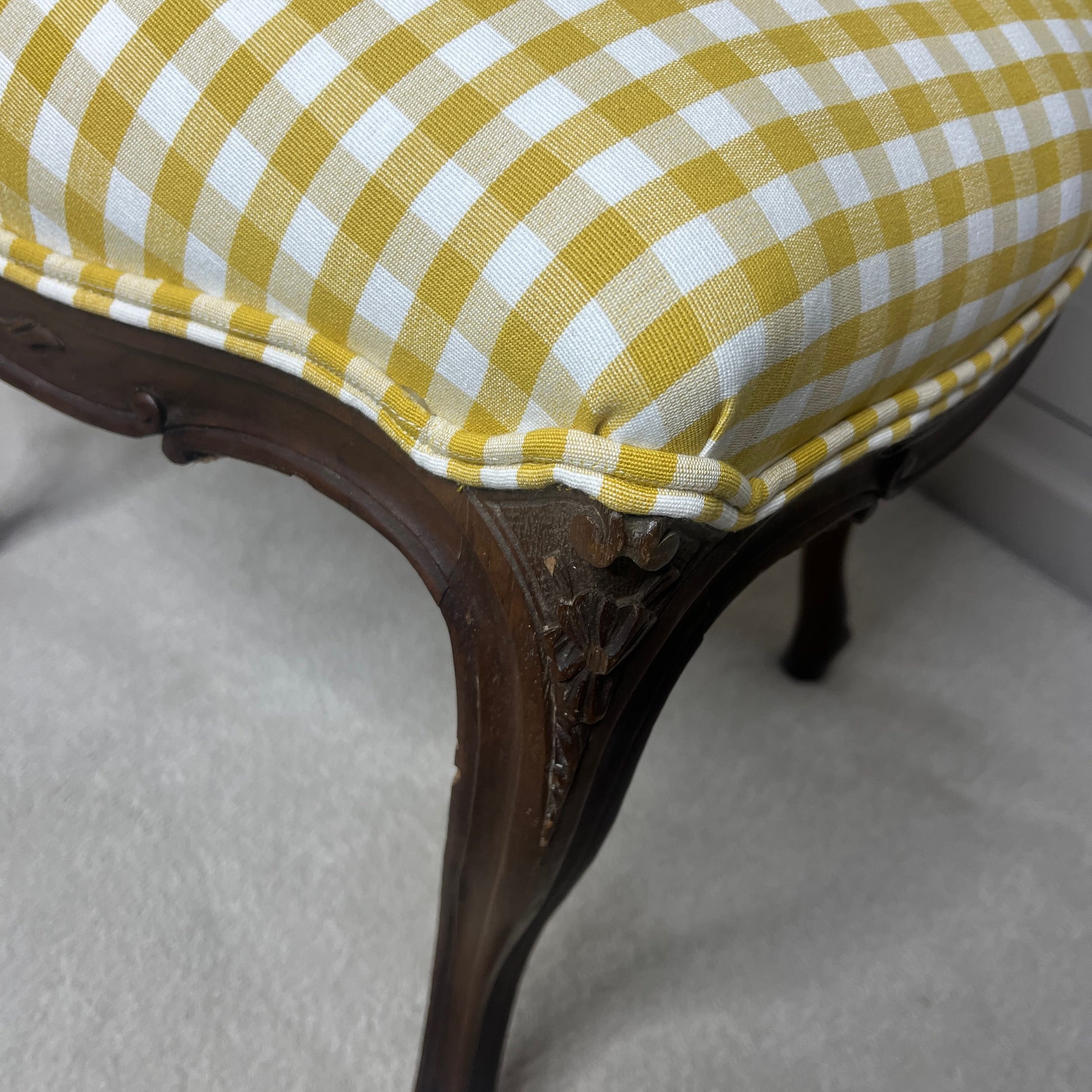 Pair of French salon chairs, newly upholstered in mustard gingham fabric, featuring elegant wooden frames and classic curved backs.