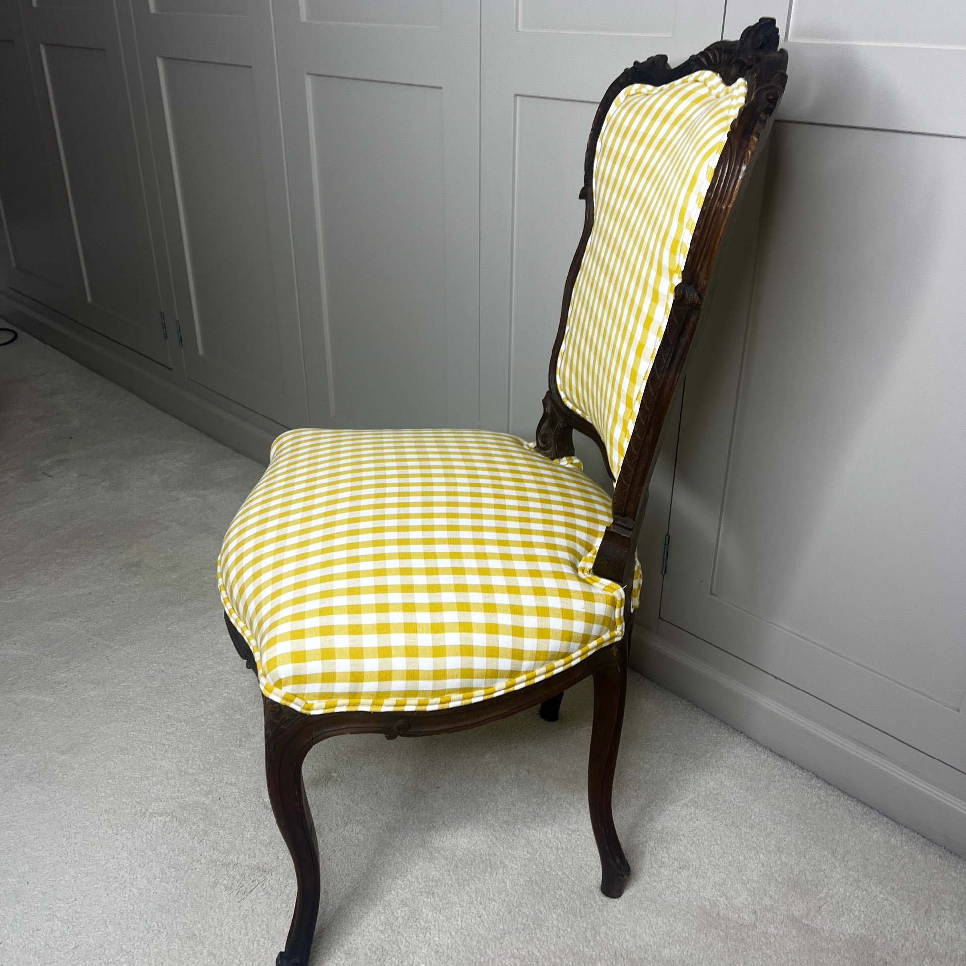 Pair of French salon chairs, newly upholstered in mustard gingham fabric, featuring elegant wooden frames and classic curved backs.
