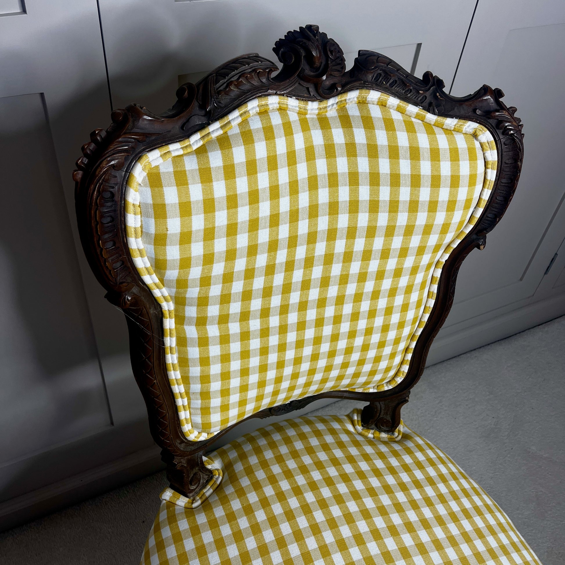 Pair of French salon chairs, newly upholstered in mustard gingham fabric, featuring elegant wooden frames and classic curved backs.