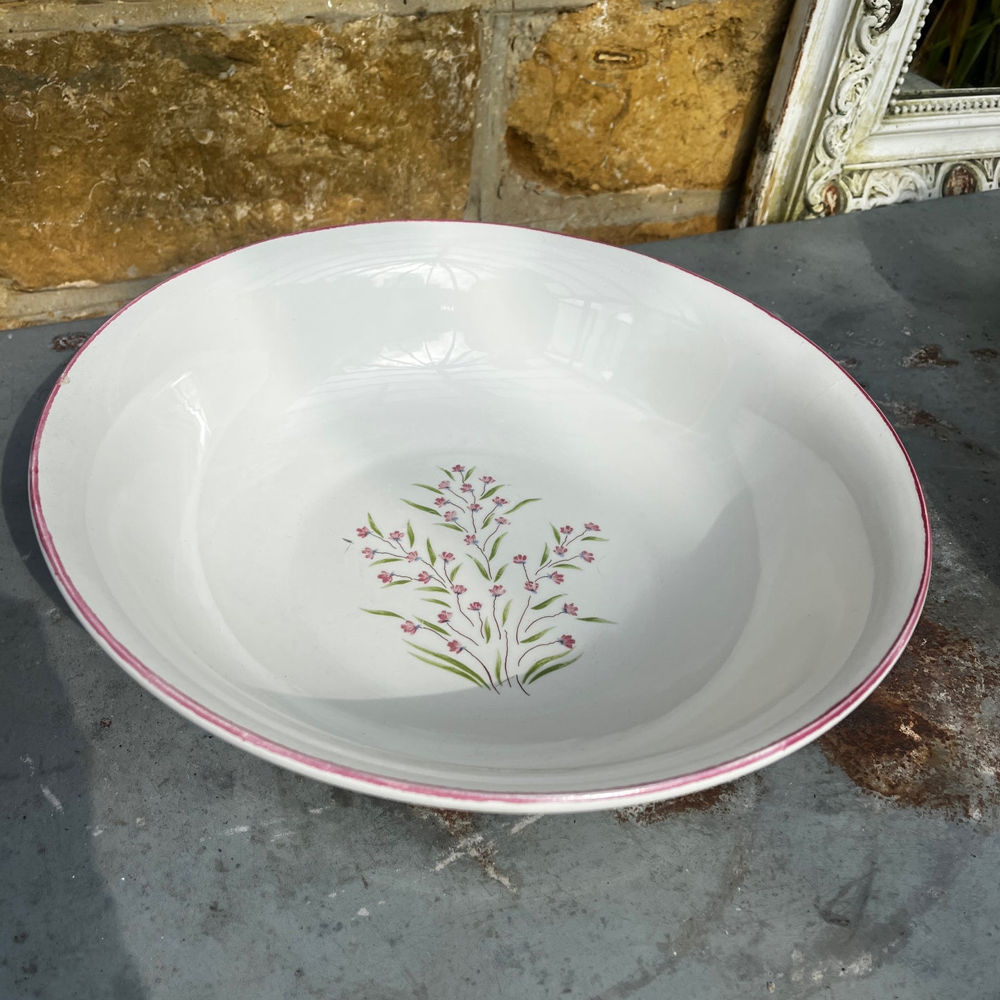 A vintage French Moulin des Loups ceramic wash basin and matching pitcher featuring a classic white glazed finish with delicate pink and green floral decoration.