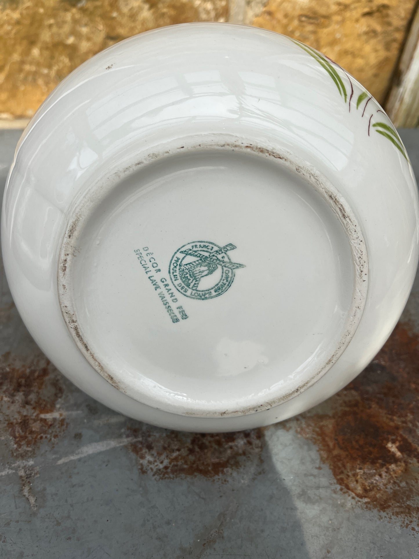 A vintage French Moulin des Loups ceramic wash basin and matching pitcher featuring a classic white glazed finish with delicate pink and green floral decoration.
