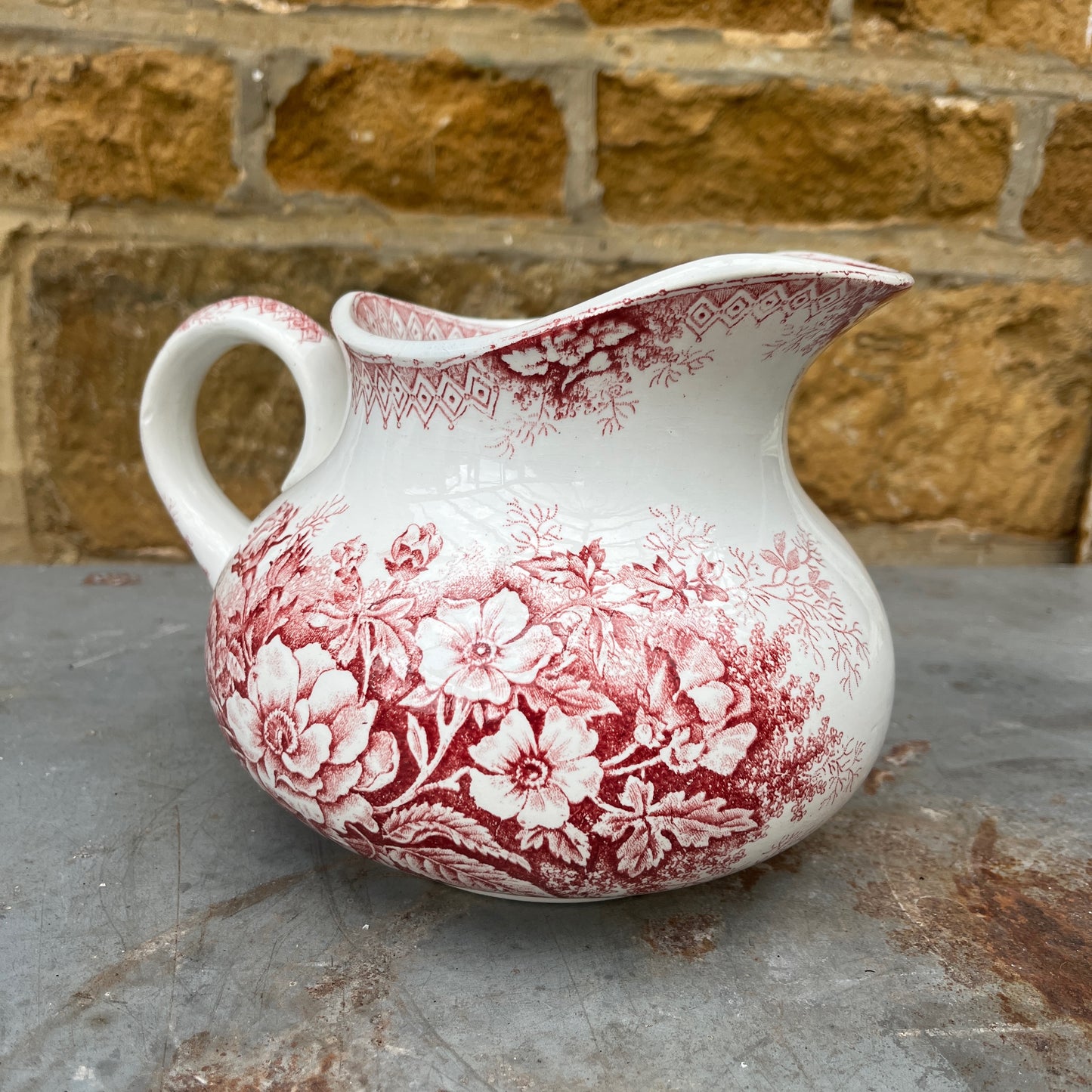 Antique French red transferware ironstone jug by Moulin des Loups, decorated with intricate red patterns and traditional detailing