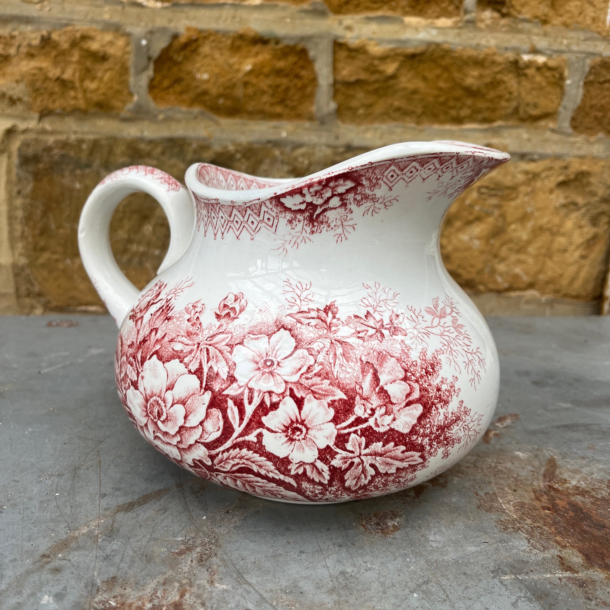 Antique French red transferware ironstone jug by Moulin des Loups, decorated with intricate red patterns and traditional detailing
