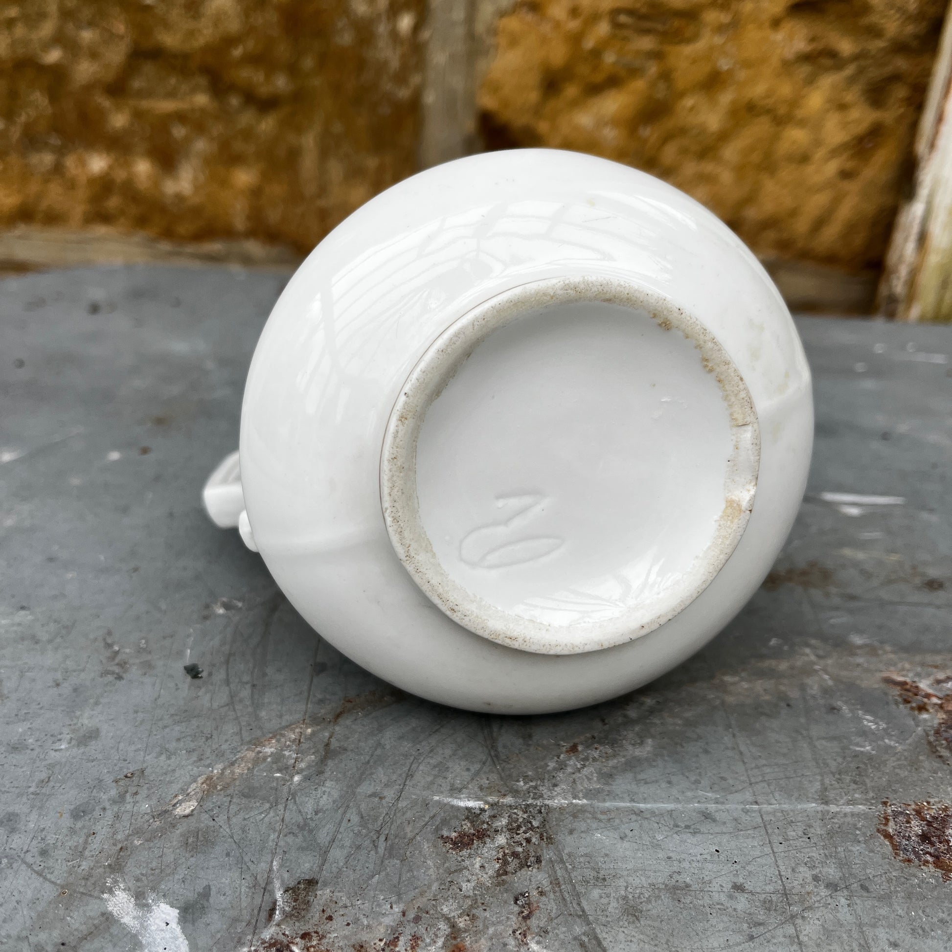 French vintage jug with a white-colored body and maroon writing detail. The jug has a classic rounded shape and a slightly aged finish, showcasing rustic, antique French charm.