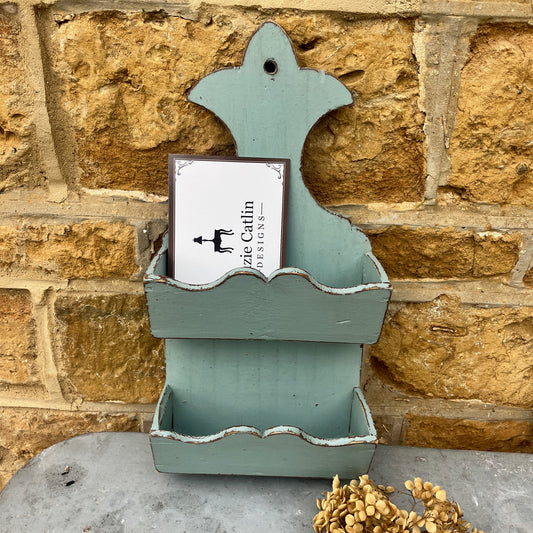 A French letter rack with a distressed wooden finish in a soft grey tone, featuring two slanted compartments for mail or letters.