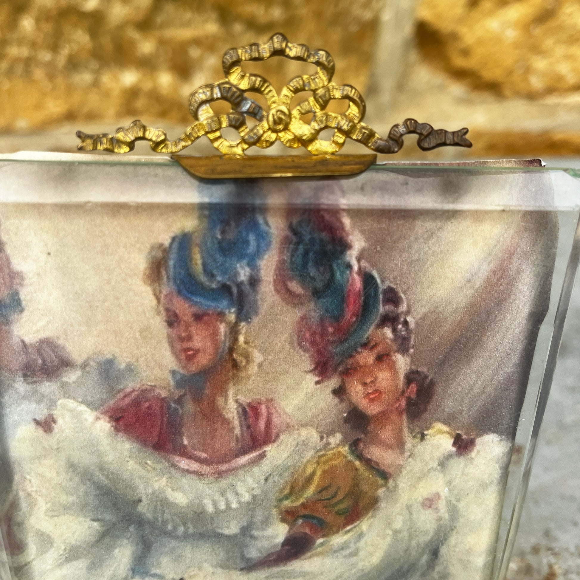 An antique French ormolu and glass photo frame featuring a bevelled glass panel and a richly aged gilt finish with a beautiful antique patina.