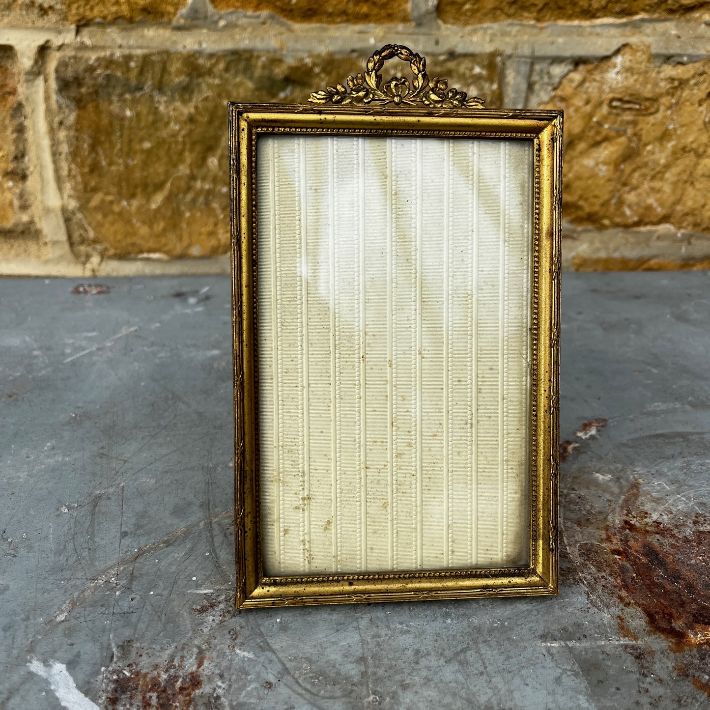 Vintage French photo frame with a gold-coloured ornate finish, featuring decorative detailing and a classic elegant design.
