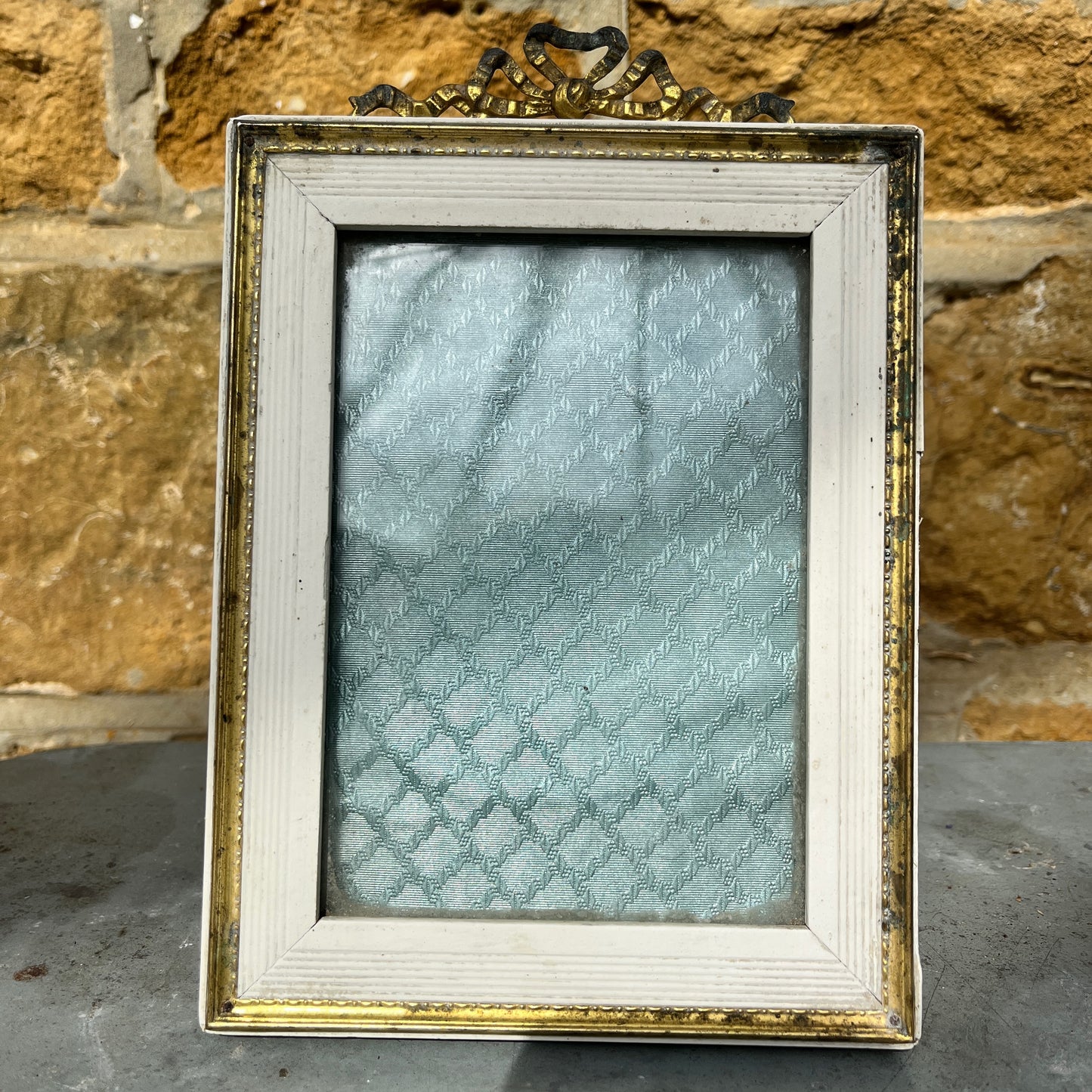 French vintage picture frames, both with silk interiors, and decorative frames; one wooden with delicate beading the other white with gold edging