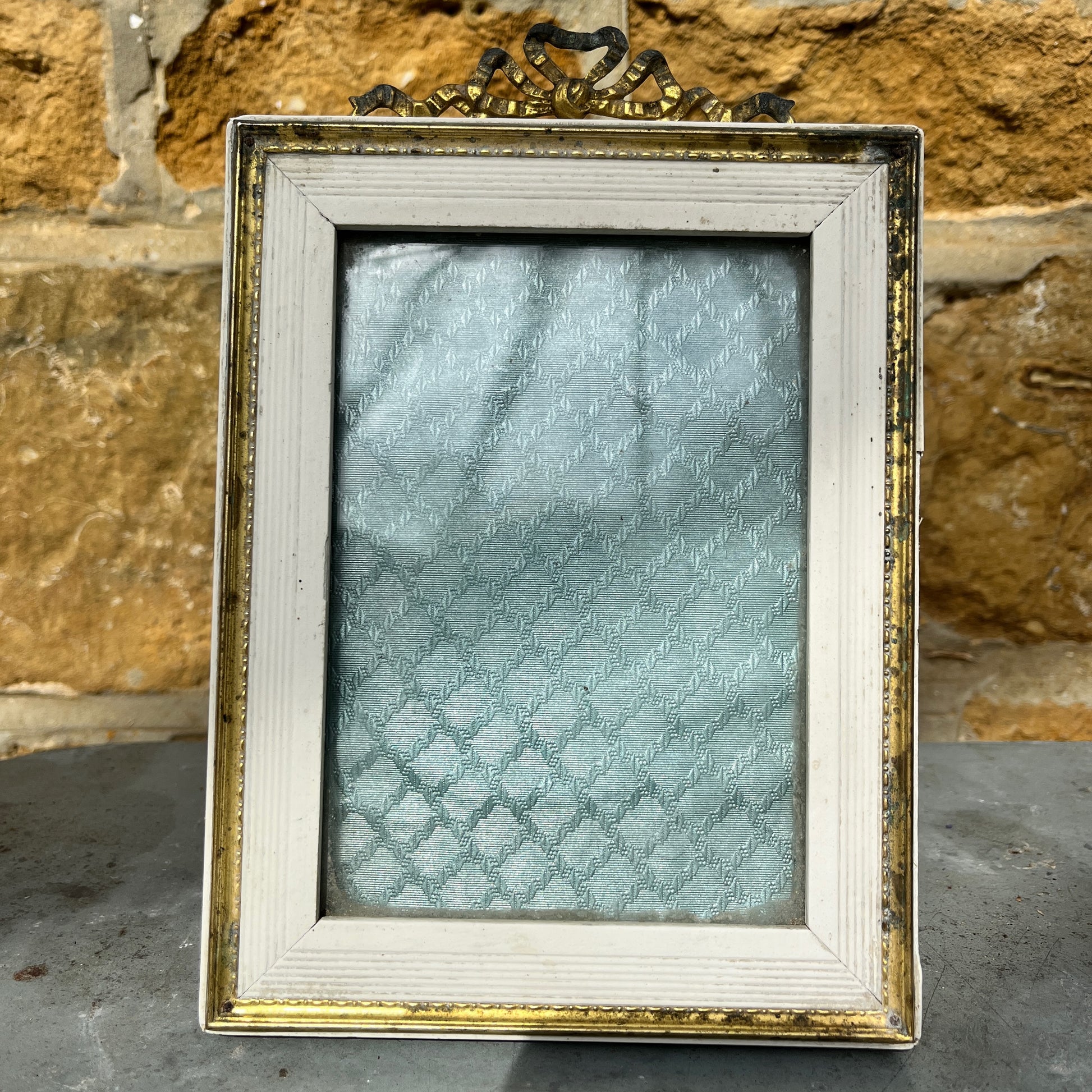 French vintage picture frames, both with silk interiors, and decorative frames; one wooden with delicate beading the other white with gold edging