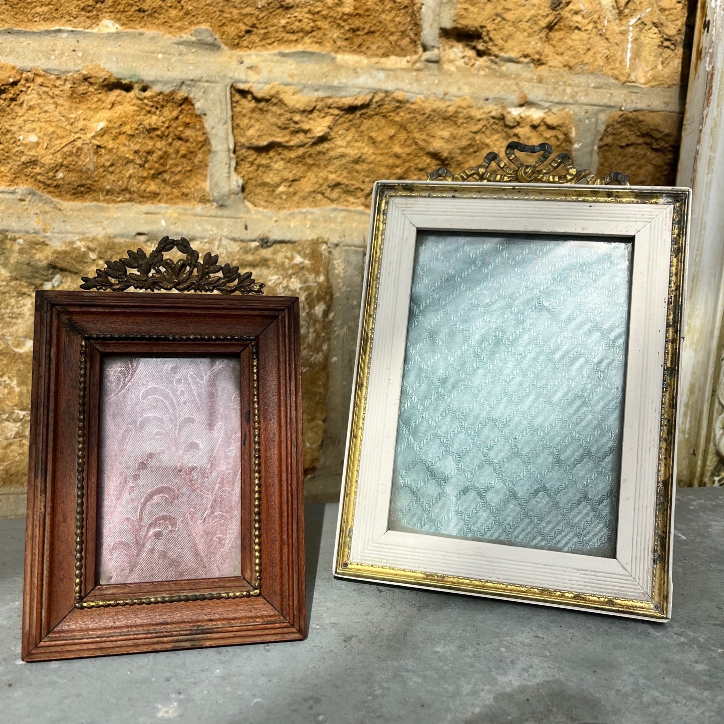 French vintage picture frames, both with silk interiors, and decorative frames; one wooden with delicate beading the other white with gold edging