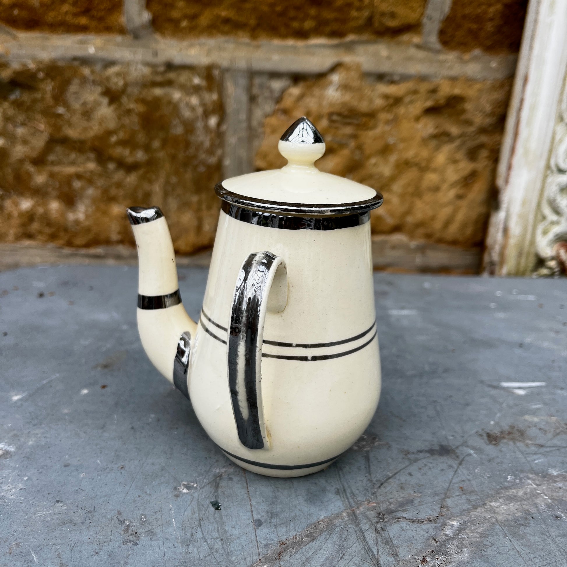 Cream-colored vintage French pot featuring delicate gilded detailing around the rim. The pot has a classic, rounded shape with a smooth glazed finish, reflecting elegant French country style.