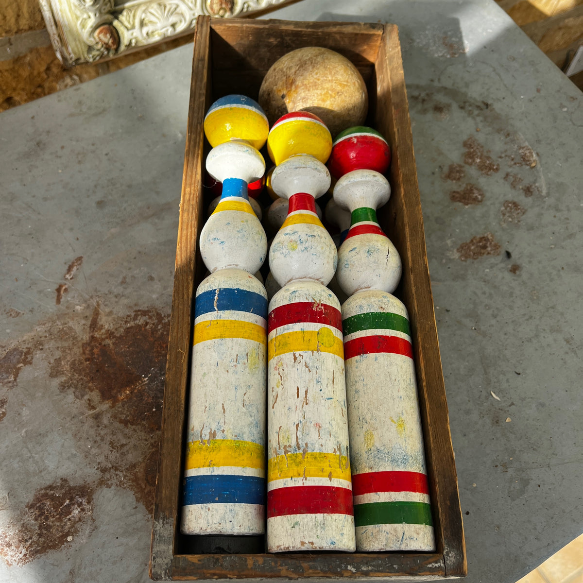 Vintage set of hand-painted French wooden skittles with a matching storage box.