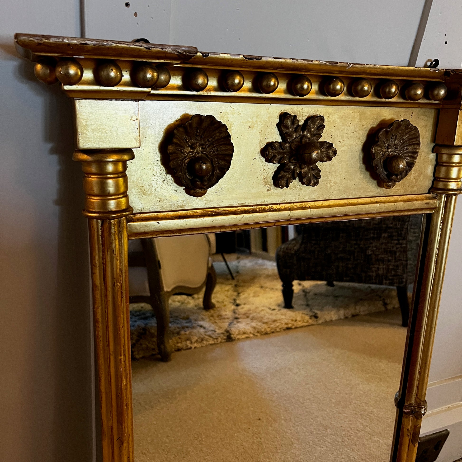 Antique gilded mirror from Grange Manor in Chesterfield, featuring an ornate gold frame with intricate decorative detailing and a richly aged finish.