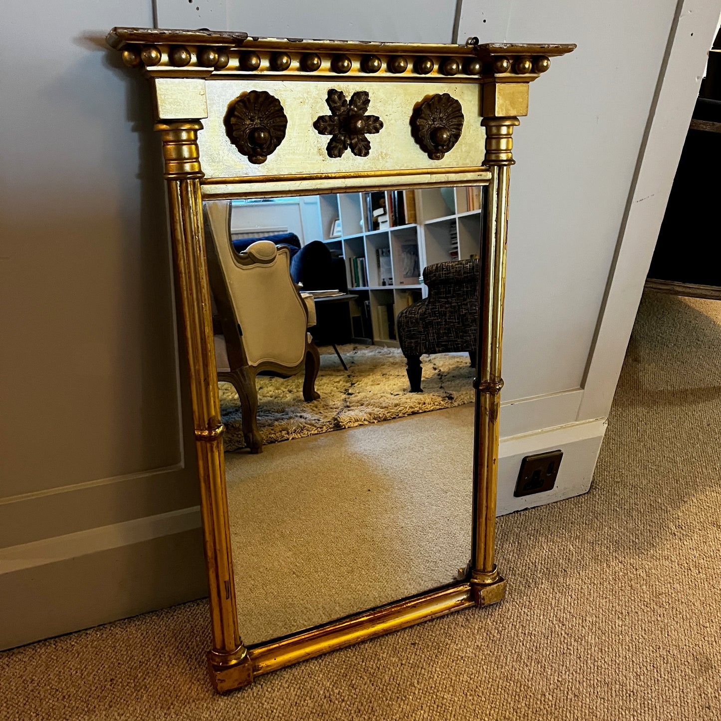 Antique gilded mirror from Grange Manor in Chesterfield, featuring an ornate gold frame with intricate decorative detailing and a richly aged finish.

