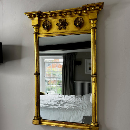 Antique gilded mirror from Grange Manor in Chesterfield, featuring an ornate gold frame with intricate decorative detailing and a richly aged finish.