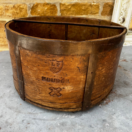 An antique English wooden dry measure with a simple cylindrical shape and a richly weathered natural wood finish.