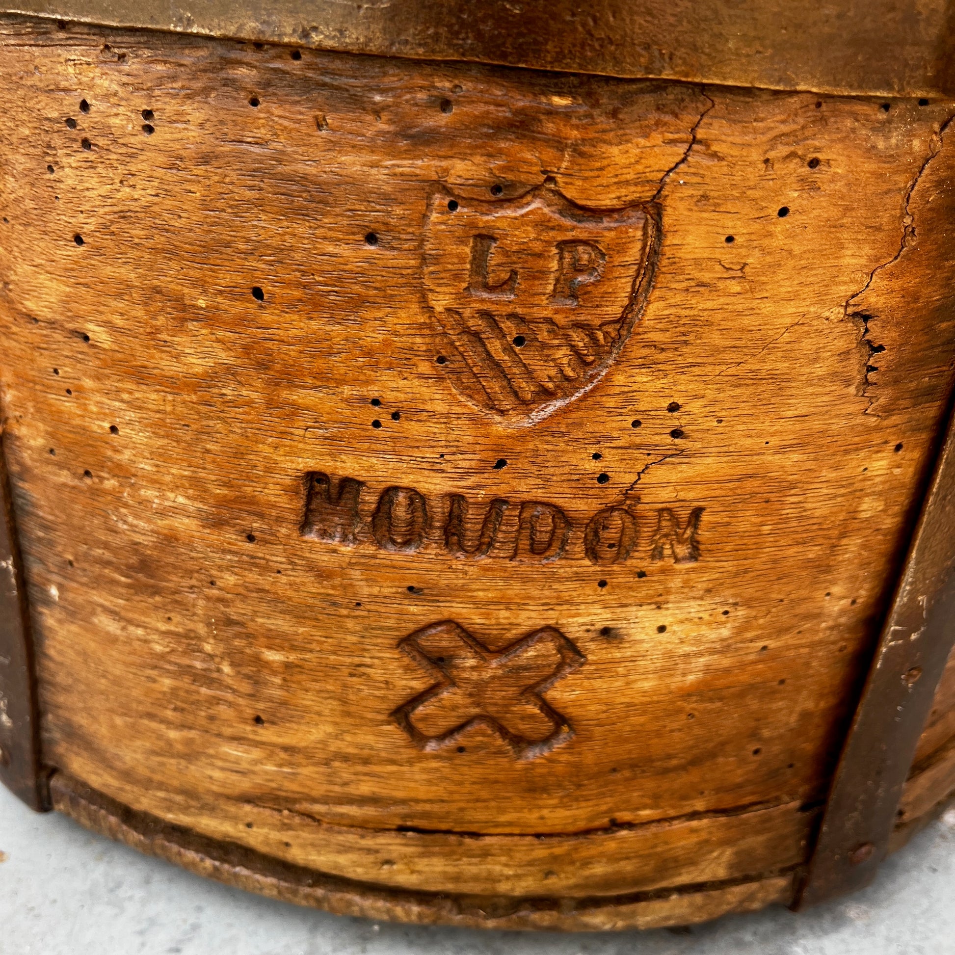 An antique English wooden dry measure with a simple cylindrical shape and a richly weathered natural wood finish.