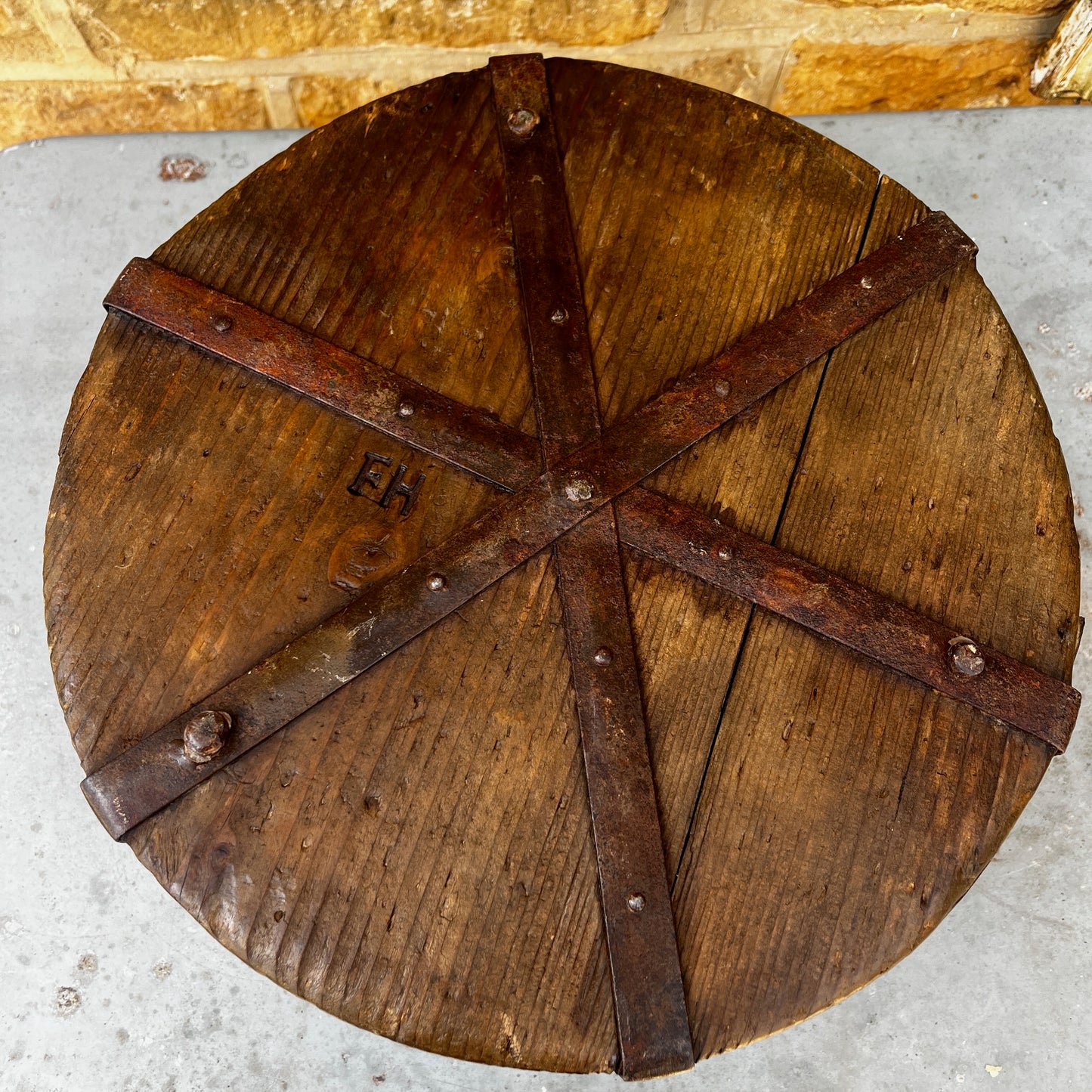 An antique English wooden dry measure with a simple cylindrical shape and a richly weathered natural wood finish.