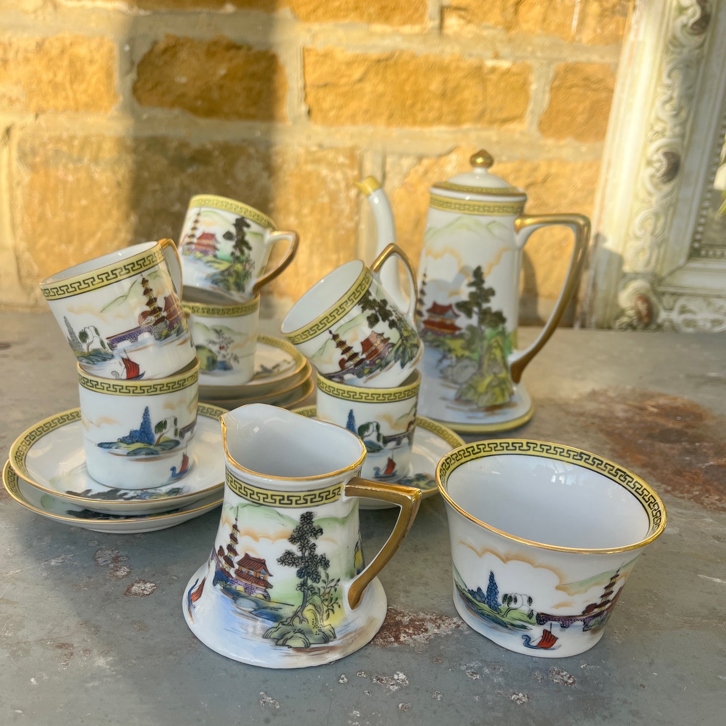 Vintage Japanese coffee / tea set by Noritake, crafted from fine porcelain with gilded accents. The set includes cups, saucers, sugar bowl, milk jug and a teapot, featuring delicate hand-painted designs and a classic, elegant finish.