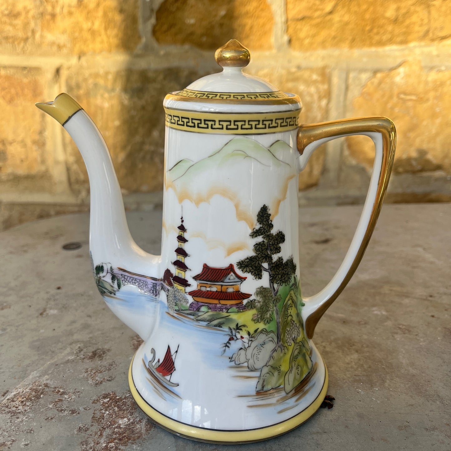 Vintage Japanese coffee / tea set by Noritake, crafted from fine porcelain with gilded accents. The set includes cups, saucers, sugar bowl, milk jug and a teapot, featuring delicate hand-painted designs and a classic, elegant finish.