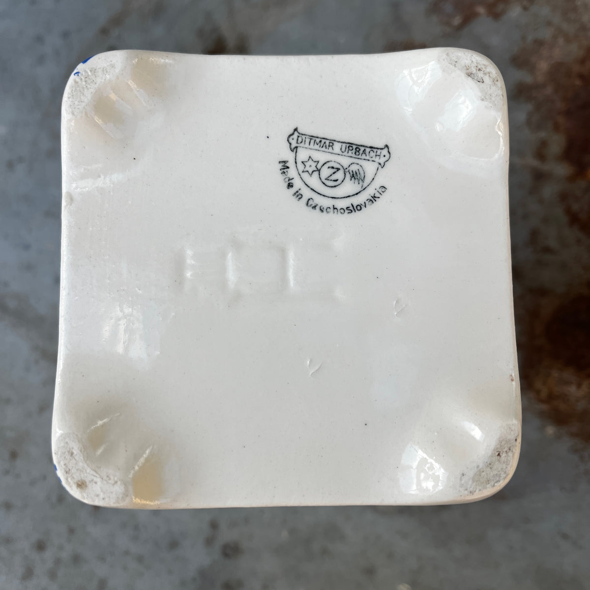 Five ceramic kitchen canisters arranged together, each decorated with a floral transfer print and French lettering on a vintage Czechoslovakian design
