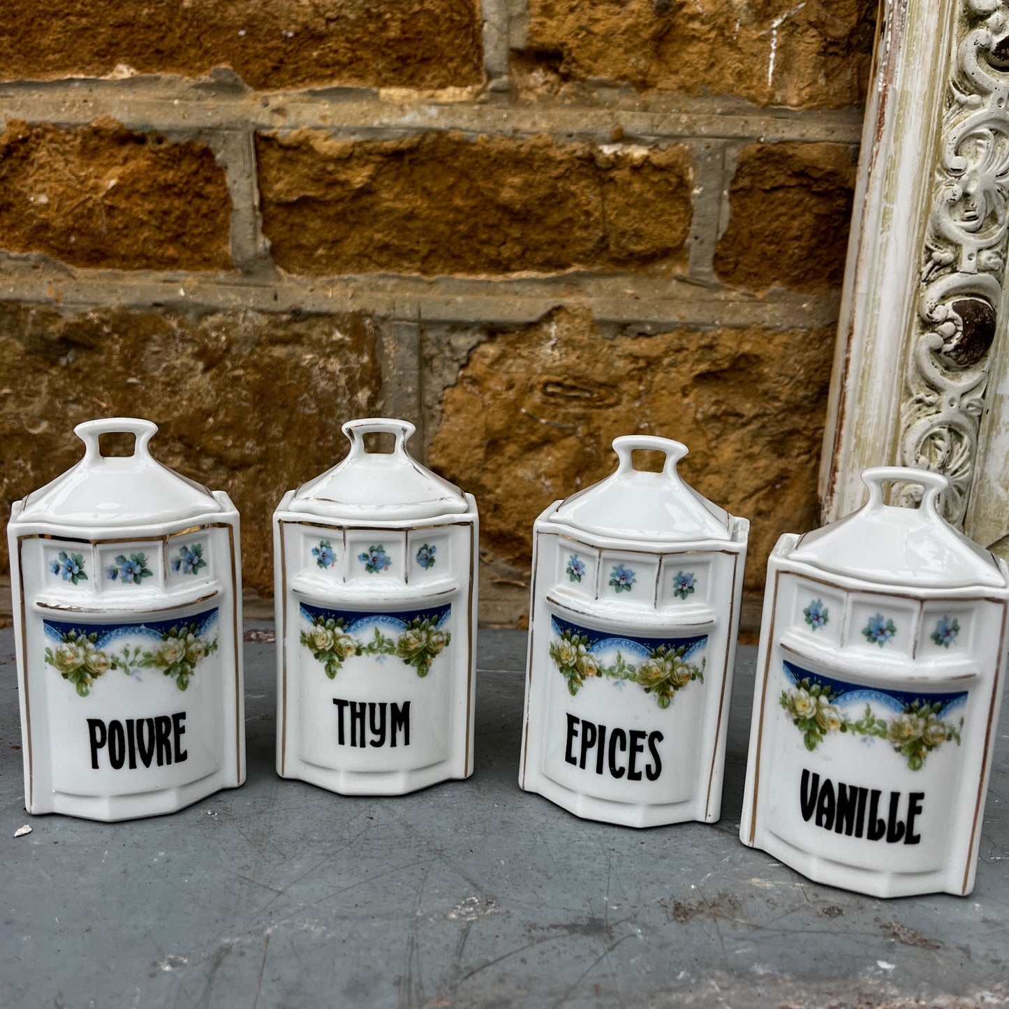 French kitchen storage canisters in white porcelain with blue, green & yellow decorative detailing. The canisters feature classic shapes, hand-painted motifs, and a timeless vintage French country style.