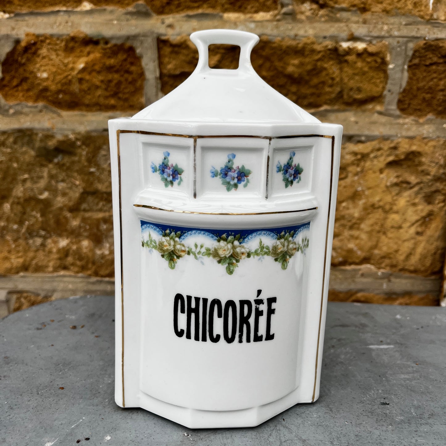 French kitchen storage canisters in white porcelain with blue, green & yellow decorative detailing. The canisters feature classic shapes, hand-painted motifs, and a timeless vintage French country style.