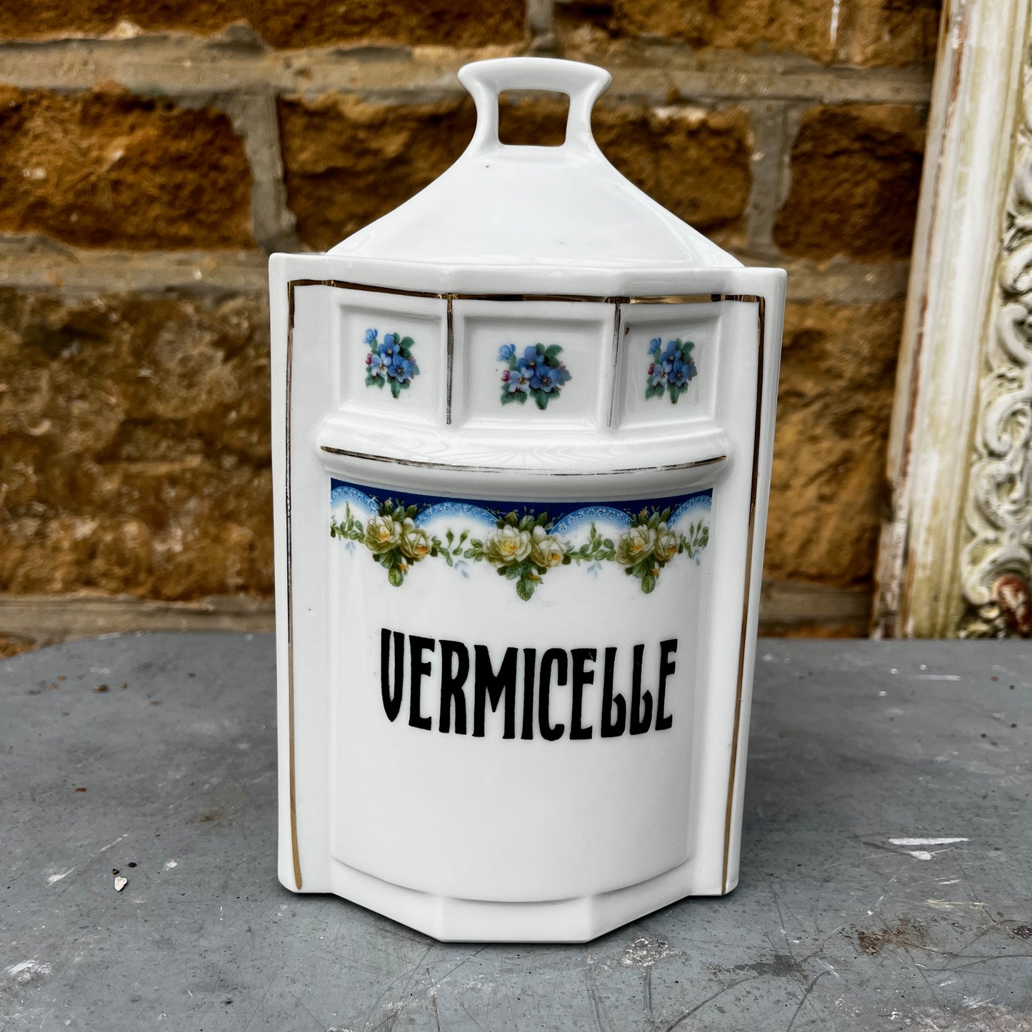French kitchen storage canisters in white porcelain with blue, green & yellow decorative detailing. The canisters feature classic shapes, hand-painted motifs, and a timeless vintage French country style.