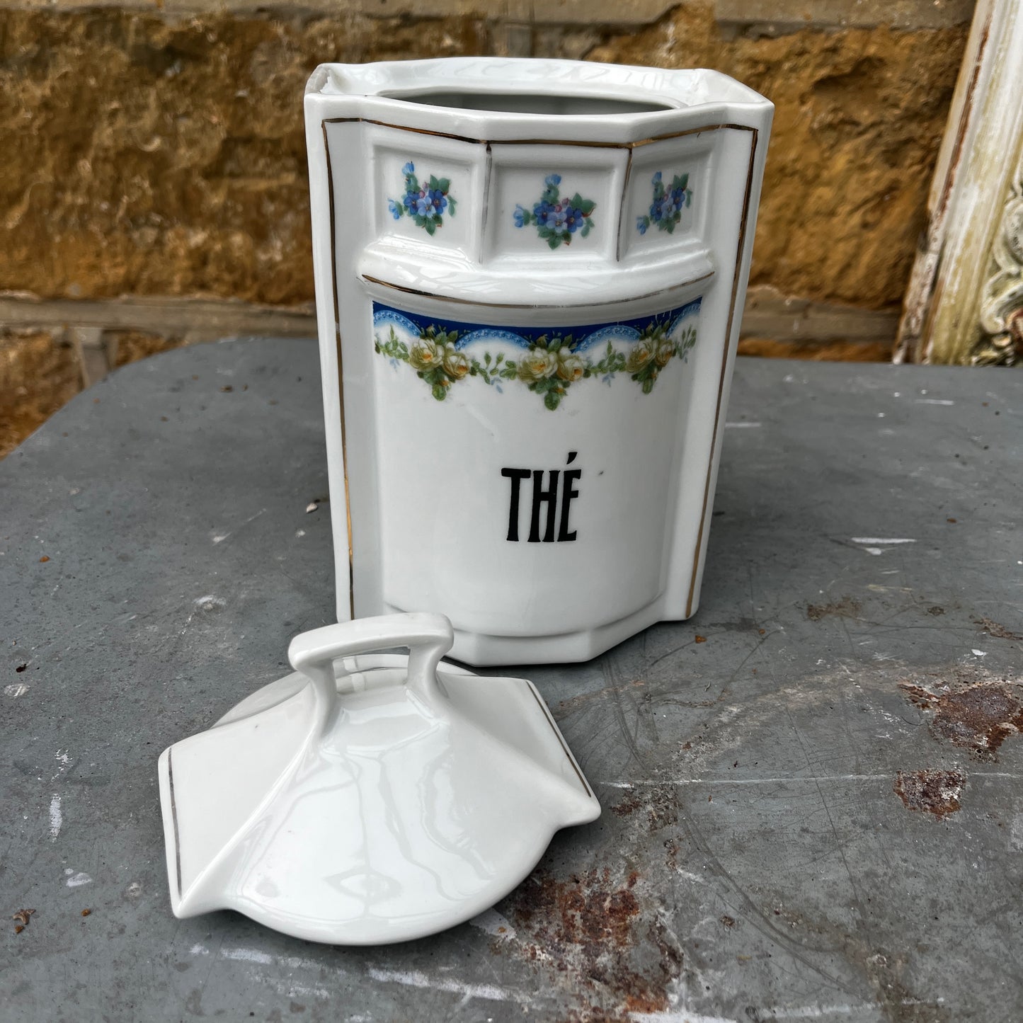 French kitchen storage canisters in white porcelain with blue, green & yellow decorative detailing. The canisters feature classic shapes, hand-painted motifs, and a timeless vintage French country style.