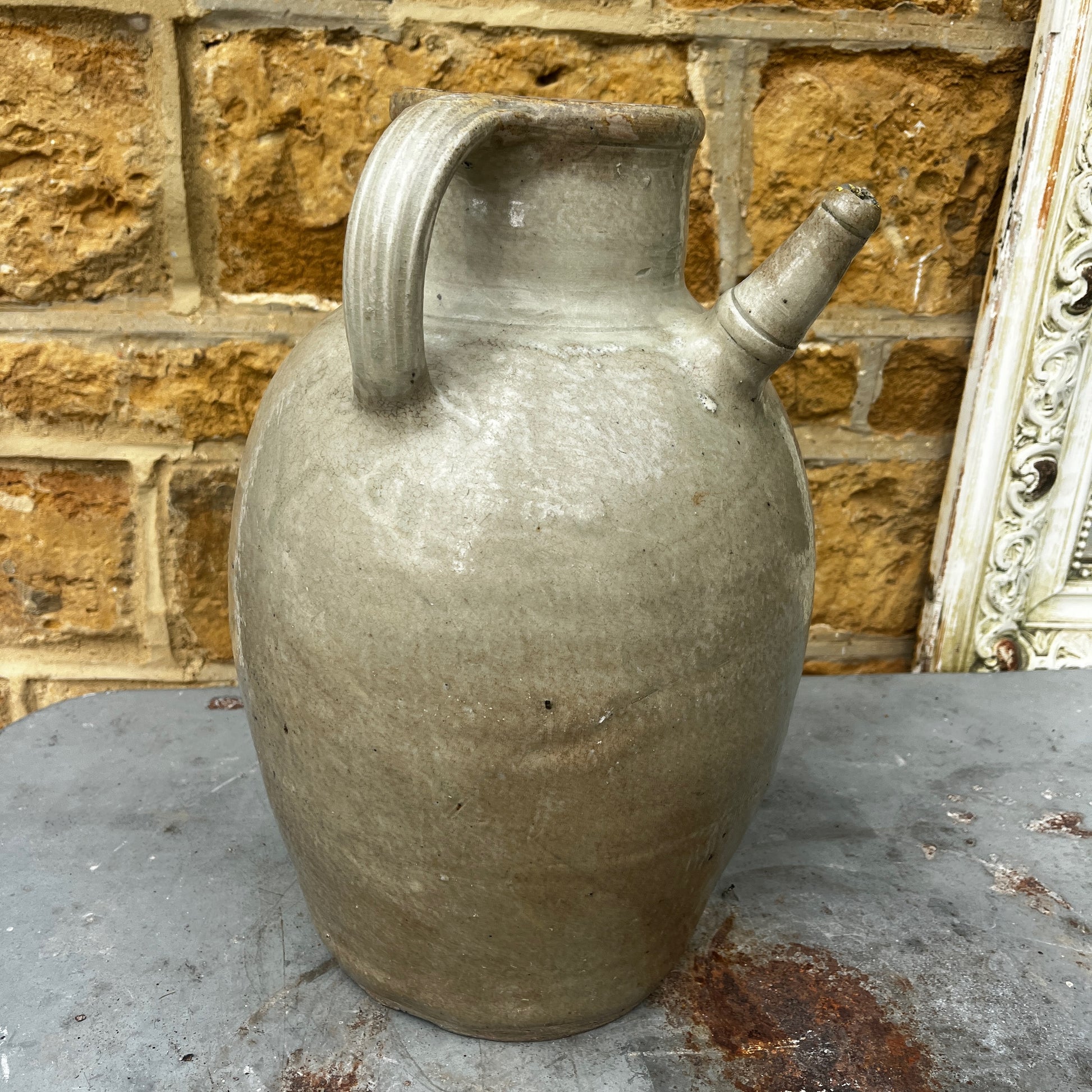 An antique glazed stoneware beehive jug with a rounded, sturdy handle, and projecting spout. The jug features a softly aged glaze with subtle variations in colour and texture, highlighting its traditional craftsmanship and rustic character.