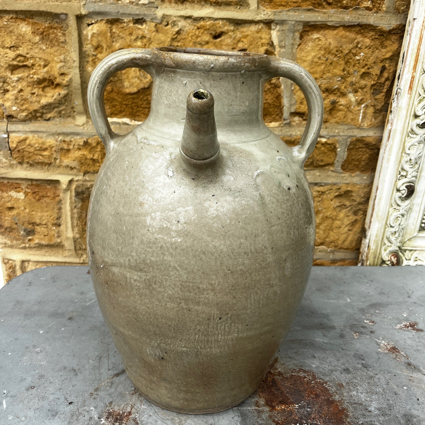 An antique glazed stoneware beehive jug with a rounded, sturdy handle, and projecting spout. The jug features a softly aged glaze with subtle variations in colour and texture, highlighting its traditional craftsmanship and rustic character.